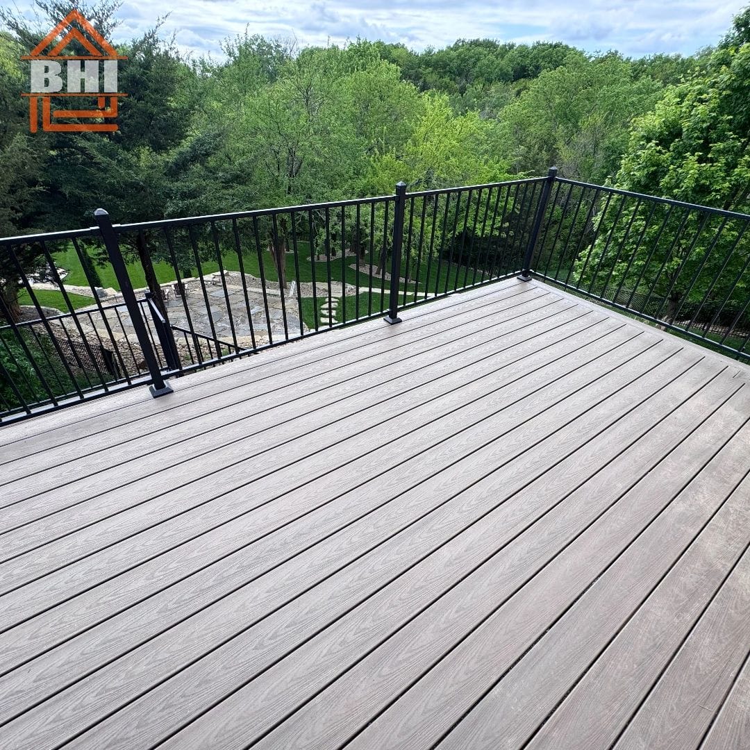 Composite deck with black railing overlooking woods built by Boyt Home Improvement