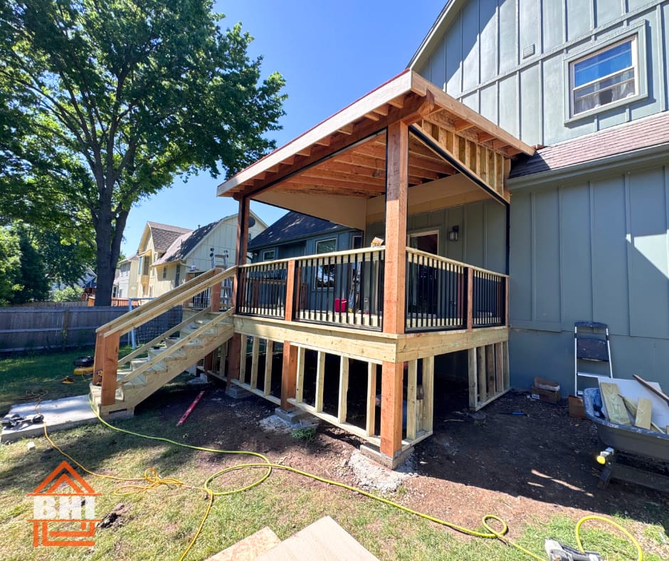 Covered deck with cedar posts and a gable roof built by Boyt Home Improvement