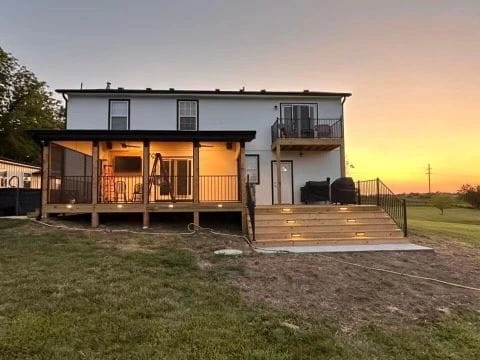 Screened-in porch and deck on a home at dusk built by Boyt Home Improvement