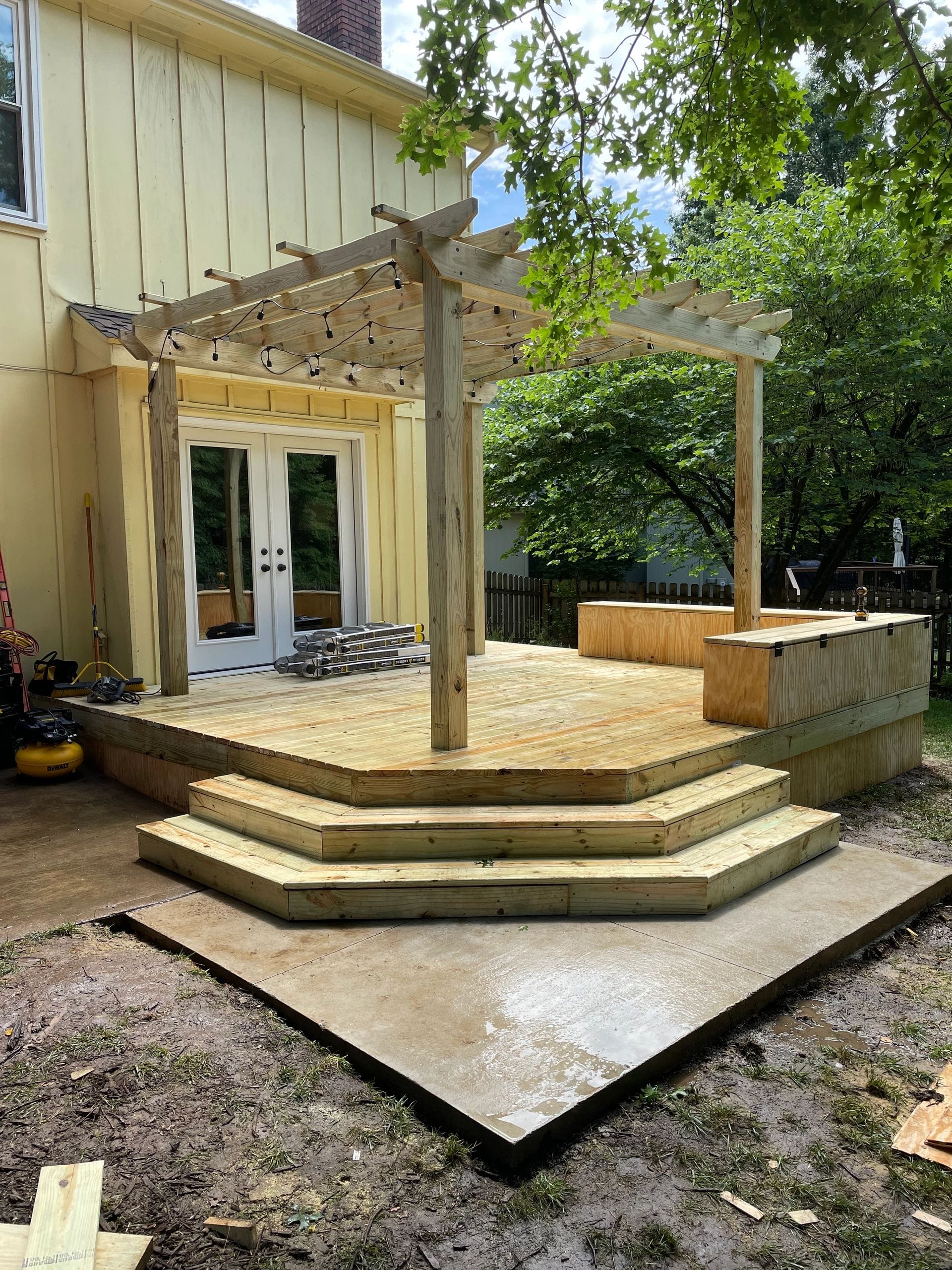 Cedar wood deck with a pergola and French doors built by Boyt Home Improvement